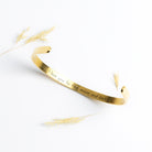 Gold Cuff Bracelet with the word "Angel" engraved in the front.  The inside reads, "I love you to the moon and back."