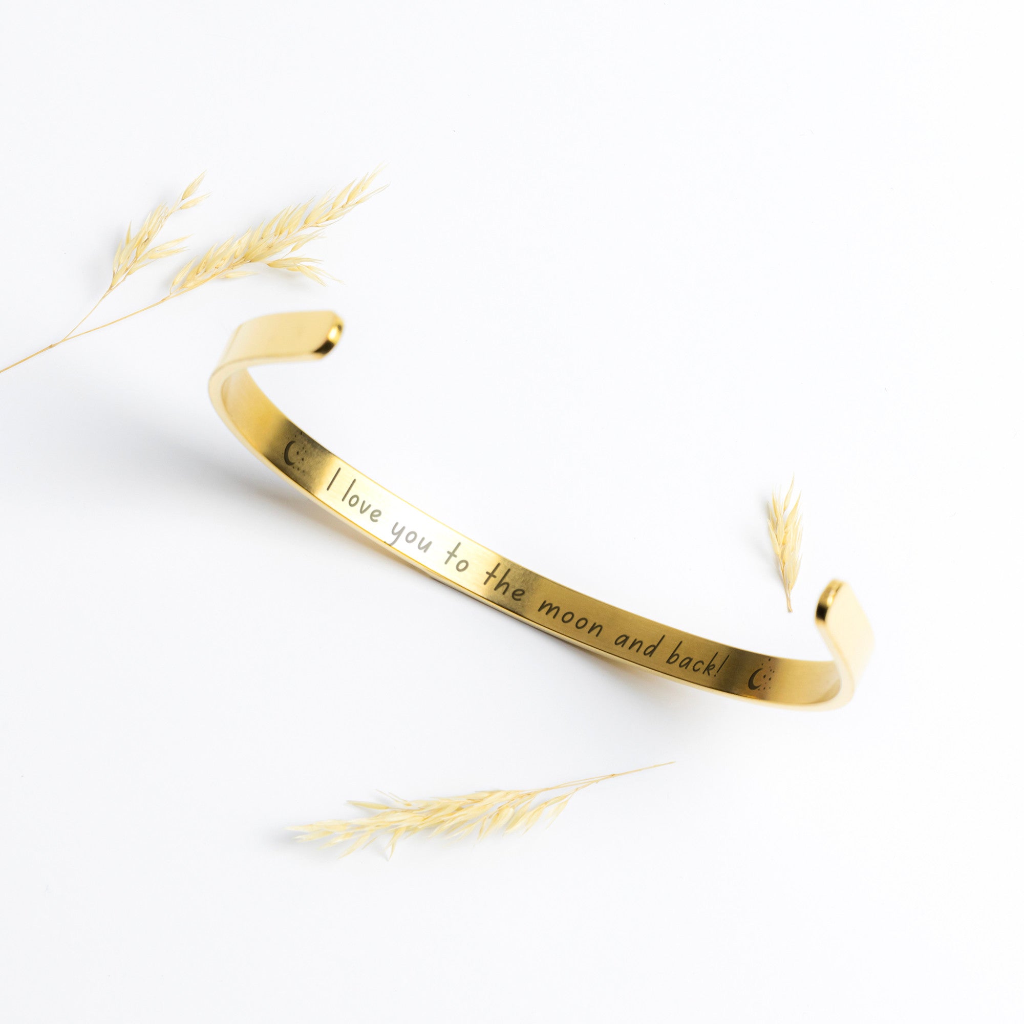 Gold Cuff Bracelet with the word "Angel" engraved in the front.  The inside reads, "I love you to the moon and back."