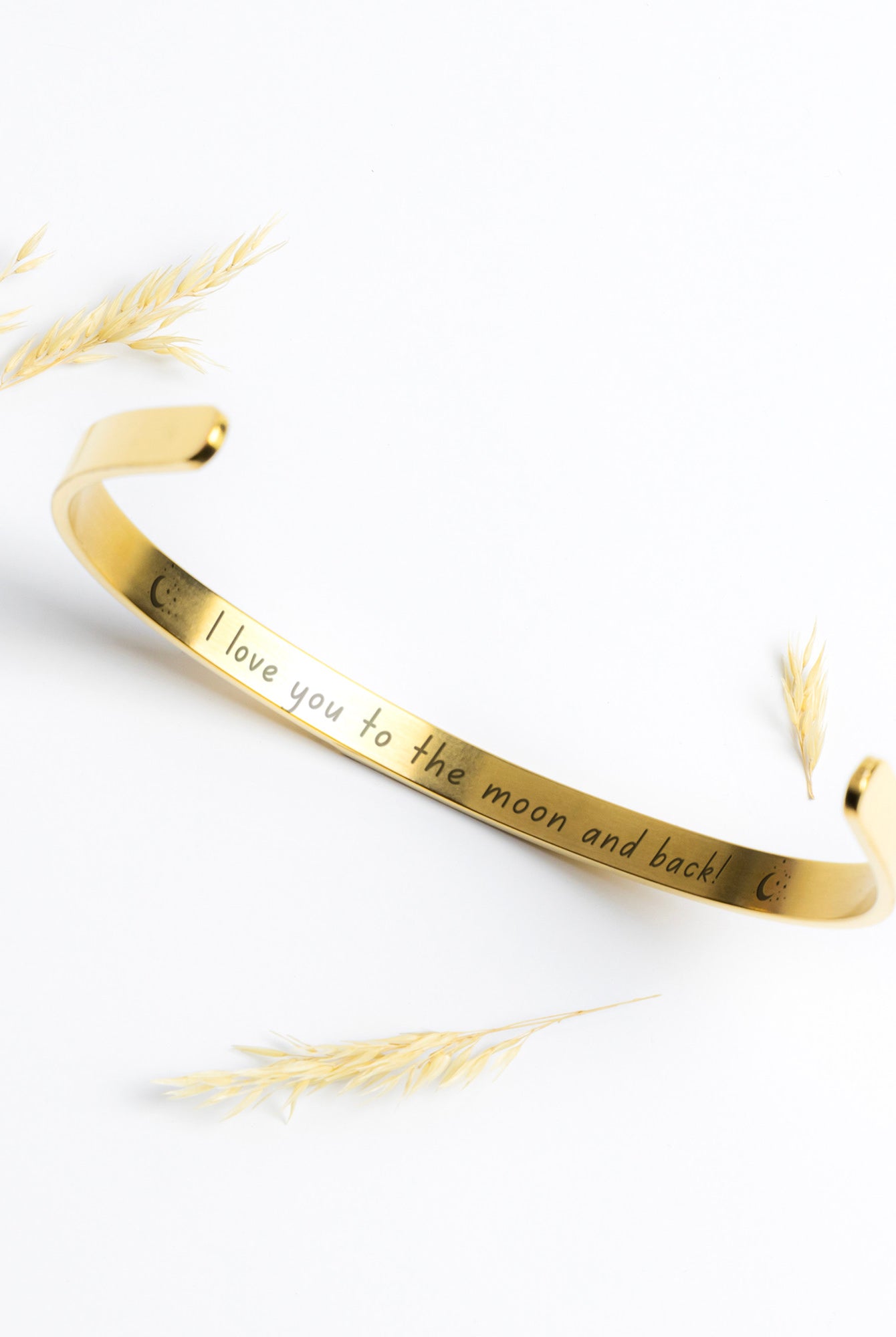 Gold Cuff Bracelet with the word "Angel" engraved in the front.  The inside reads, "I love you to the moon and back."