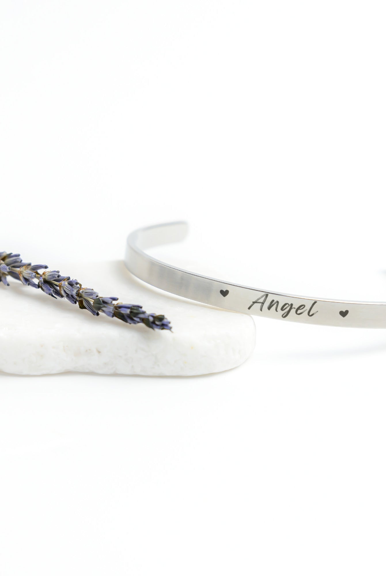 Silver Cuff Bracelet with the word "Angel" engraved in the front.  The inside reads, "I love you to the moon and back."