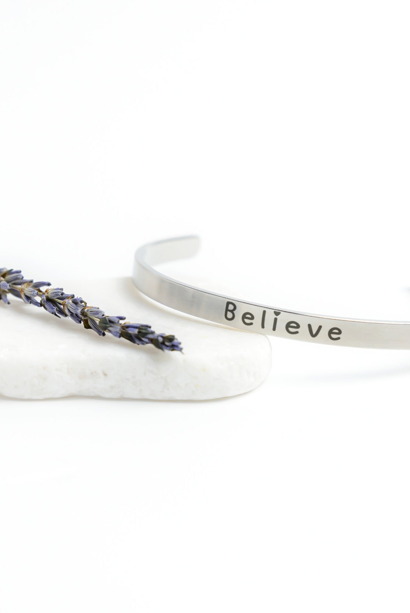 Silver Cuff Bracelet with the word "Believe" written on the outside.  The inside reads, "Believe in the beauty of your journey."