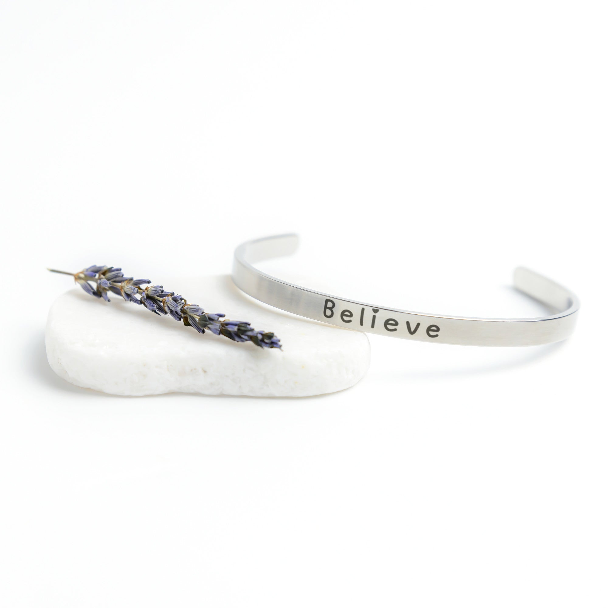 Silver Cuff Bracelet with the word "Believe" written on the outside.  The inside reads, "Believe in the beauty of your journey."
